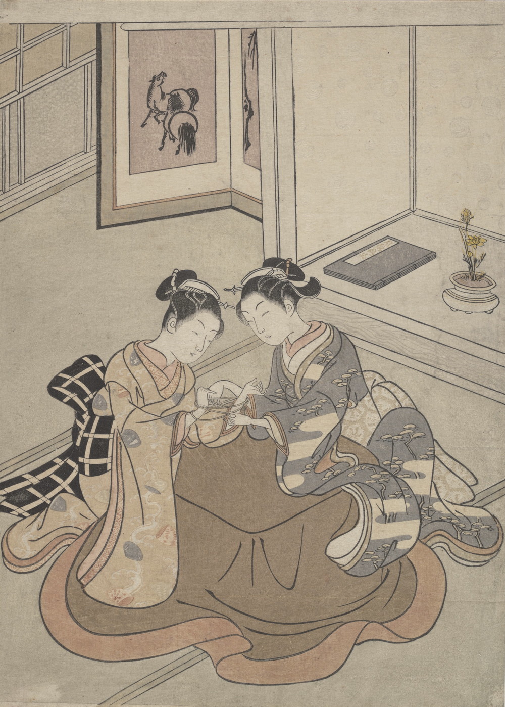 あやとりをする少女と女性